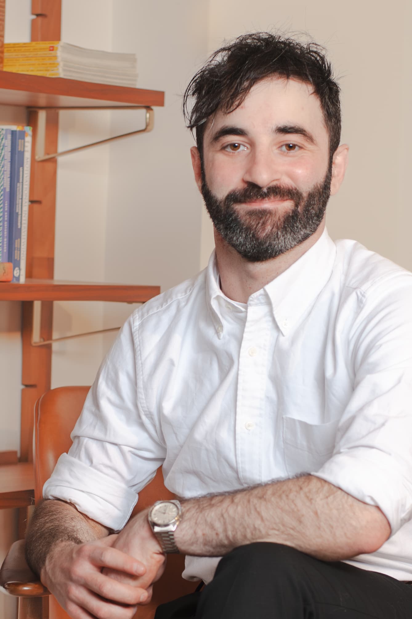 Dr. Joseph Rootman seated in a warm office with bookshelves.