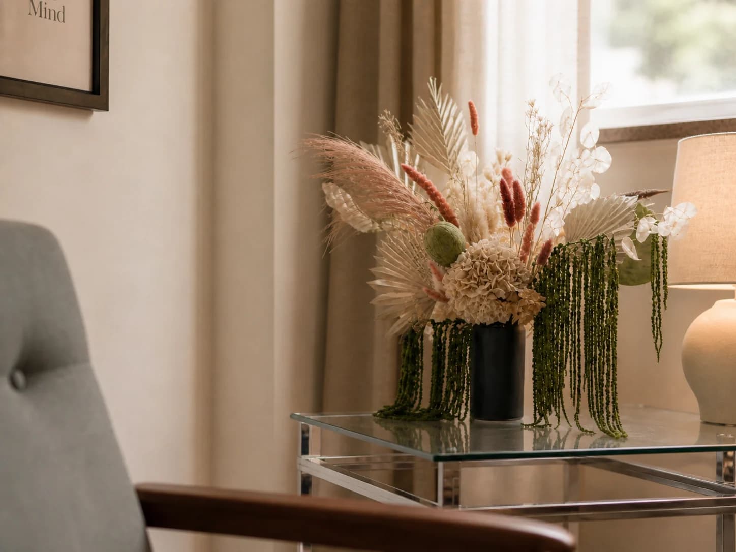 Two chairs beside a warm lamp and floral arrangement in a quiet therapy room.